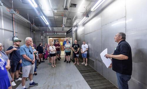 A group of people having a tour around the Avionics Building