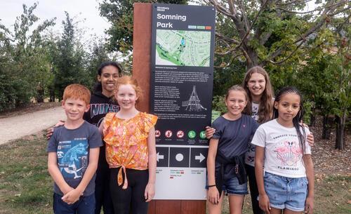 Group of children at Somning Park wayfinding sign