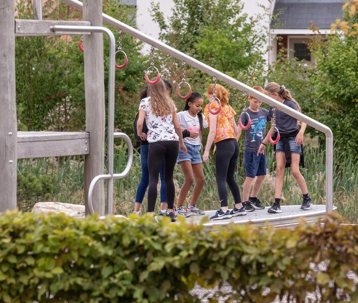 A group of school age children playing at Hallowes Brook